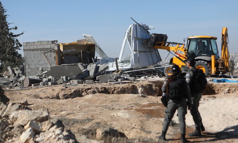 A bulldozer demolishes a Palestinian house, which the Israelis claim to have built without a permit, in the village of Yatta, south of the West Bank city of Hebron, on December 6, 2021. (Photo: Xinhua)
