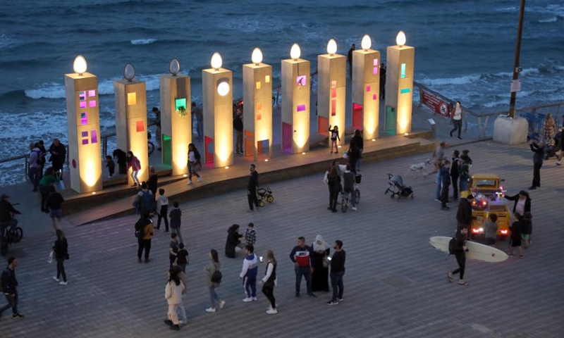 People visit a giant Hanukkah menorah during the Jewish holiday of Hanukkah in Tel Aviv on Dec. 3, 2021.(Photo: Xinhua)