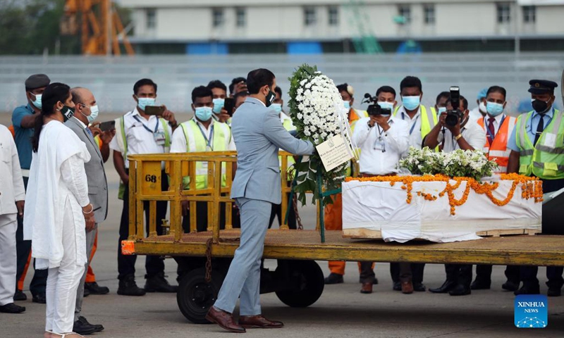 The remains of Priyantha Kumara, a Sri Lankan manager killed by a mob in Pakistan last week, arrive at the Bandaranaike International Airport in Colombo, Sri Lanka, Dec. 6, 2021. Kumara, who was employed in a factory in Sialkot in Pakistan as an export manager, was brutally killed by a mob on Friday on allegations that he tore a poster pasted on the wall of the factory bearing religious sentiments.(Photo: Xinhua)