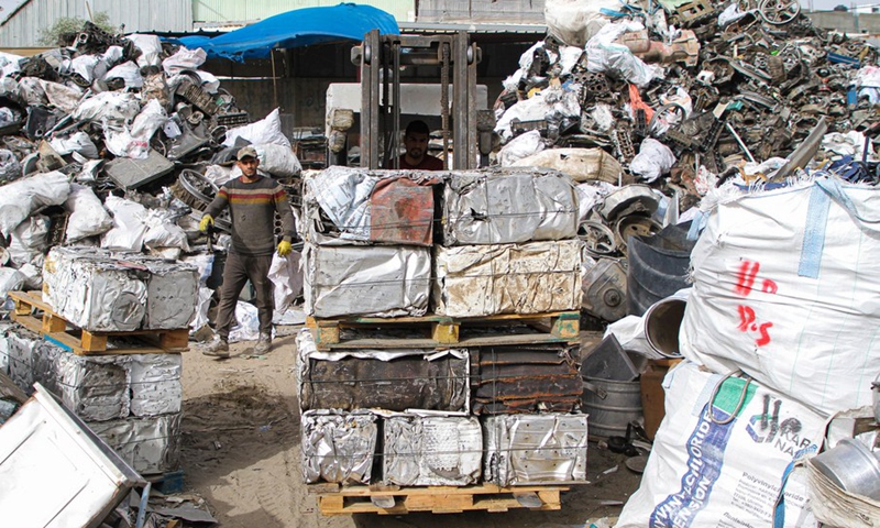 Workers collect damaged batteries at a shop in the southern Gaza Strip city of Khan Younis, on Dec. 8, 2021.(Photo: Xinhua)
