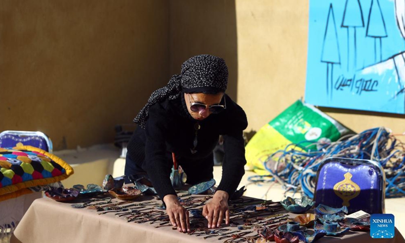 An artisan arranges her products during a handmade products fair at Fayoum Art Center in Tunis village of Fayoum, Egypt, Dec. 10, 2021.Photo:Xinhua