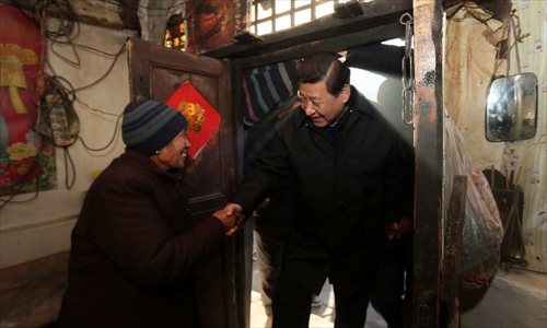 Xi Jinping (R), general secretary of the Communist Party of China (CPC) Central Committee and chairman of the CPC Central Military Commission, visits the family of Tang Rongbin, an impoverished villager in the Luotuowan Village of Longquanguan Township, Fuping County, north China's Hebei Province. Xi made a tour to impoverished villages in Fuping County from Dec. 29 to 30, 2012.  Photo: Xinhua