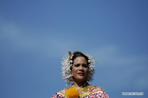 A woman wearing the traditional dress of Pollera participates in the Parade of 1,000 Polleras in Las Tablas, Panama, on Jan. 12, 2013. Polleras are traditional handmade costumes worn by Panamanian women mostly in folklore festivities. According to parade organizers, almost every part of the costume is made by hand and the assortment of head, neck and chest jewelry worn with a pollera can cost as much as 20,000 U.S. dollars. (Xinhua/Mauricio Valenzuela)  