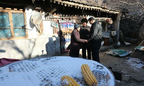 Xi Jinping (R), general secretary of the Communist Party of China (CPC) Central Committee and chairman of the CPC Central Military Commission, says goodbye to Tang Rongbin (C), an impoverished villager, and his wife in the Luotuowan Village of Longquanguan Township, Fuping County, north China's Hebei Province, Dec. 30, 2012. Xi made a tour to impoverished villages in Fuping County from Dec. 29 to 30, 2012.  Photo: Xinhua