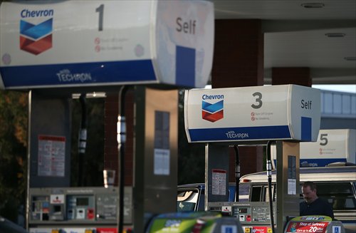 The Chevron logo is displayed on gas pumps at a Chevron gas station on Friday in Greenbrae, California, US. Chevron Corp reported a 27 percent plunge in first-quarter profits, hit by low prices and volumes for crude oil, with earnings of $4.51 billion, or $2.36 a share, compared to $6.18 billion, or $3.18 a share, one year ago. Photo: AFP