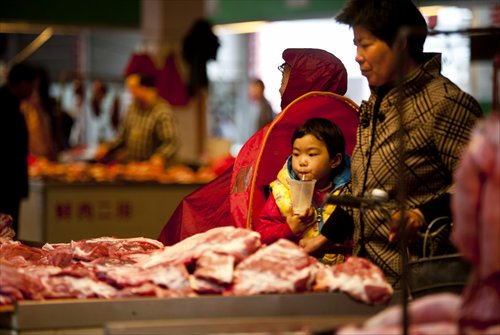 A woman and a child look at meat at a market in Haian, East China’s Jiangsu Province on Sunday. Food prices rose by 4.1 percent year-on-year in March, according to consumer price index (CPI) data from the National Bureau of Statistics on Friday. The overall CPI was up 2.4 percent year-on-year. Photo: CFP