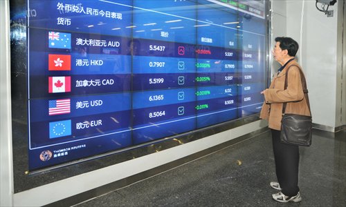A man looks at the exchange rate information in Shanghai. China reported both current account and capital account surplus in the January-March period, and its newly added foreign exchange reserves totaled $125.8 billion in the first quarter of this year, the State Administration of Foreign Exchange said on Thursday. Photo: IC