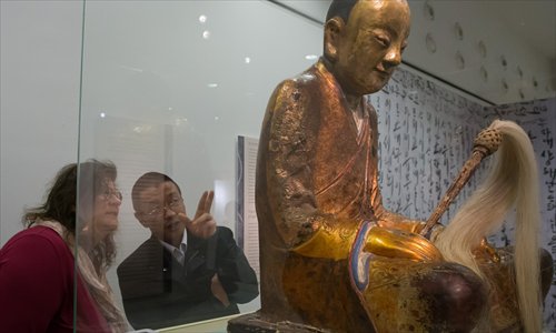 A Chinese mummy Buddha statue is admired by visitors to the Hungarian Natural History Museum in Budapest, Hungary on March 3, 2015. The statue, which conceals the mummified remains of an ancient monk, was withdrawn from the museum by its Dutch owner. Villagers living in Yangchun, a village in East China's Fujian Province, claim that this statue is the one stolen from their village's temple in 1995, Chinese media reported. Photo: Xinhua/Attila Volgyi