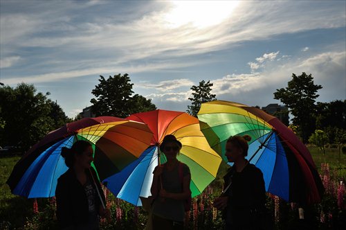 A group of women hold rainbow umbrellas to celebrate the International Day against Homophobia. Photo: IC