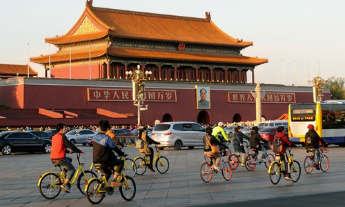 People ride shared bicycles in Beijing. Photos: CFP