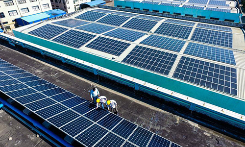 Technicians check solar energy equipment on a roof in Cixi City, east China's Zhejiang Province, May 10, 2017. (Xinhua/Xu Yu)