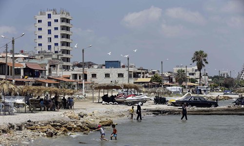 Syrians spend time on the shores of the Mediterranean Sea in the northwestern city of Latakia on July 7. Photo: CFP