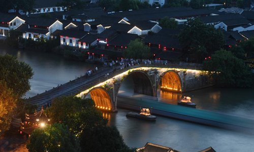 A cargo ship sails across the Gongchen Bridge over the Grand Canal in Hangzhou, east China's Zhejiang Province, July 20, 2017. A cultural and scenic belt, including museums, cultural and creative zones, historical relics and ancient streets, has formed along the 12-kilometer-long section of the Beijing-Hangzhou Grand Canal in Gongshu District of Hangzhou. (Xinhua/Huang Zongzhi)