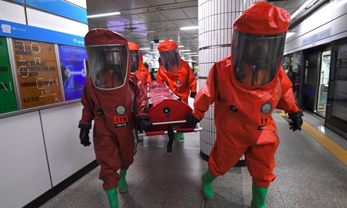 South Korean rescue members wearing chemical protective suits take part in an anti-terror drill at a subway station in Seoul on Tuesday, on the sidelines of a South Korea-US joint military exercise. Tens of thousands of South Korean and US troops are taking part in the 