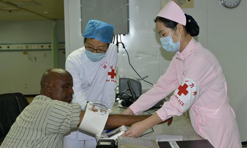 Medical workers check blood pressure for a man in the Chinese hospital ship Peace Ark in Djibouti, on Aug. 24, 2017. The Peace Ark arrived in Djibouti on Wednesday and was expected to carry out a nine-day medical service in Djibouti. It will then travel to Sierra Leone, Gabon, Tanzania and other countries to provide free medical and humanitarian services.Photo: Xinhua