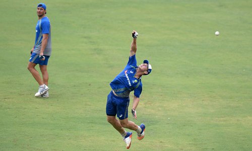 Australian cricketer Hilton Cartwright dives to take a catch during a training session ahead of the India-Australia cricket series in Chennai, India on Thursday. India and Australia will play five ODIs and three Twenty20 matches during the tour lasting nearly a month, starting Sunday. Photo: AFP
