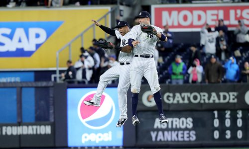The New York Yankees' Aaron Judge (right) and Aaron Hicks celebrate after defeating the Houston Astros in Game 3 of the American League Championship Series at Yankee Stadium on Monday, in New York City. Photo: VCG