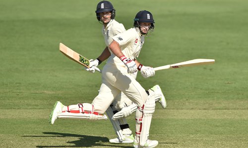 England captain Joe Root (right) and Dawid Malan run between the wickets on the second day of a four-day Ashes tour match against a Cricket Australia XI in Townsville, Australia on Thursday. Photo: AFP