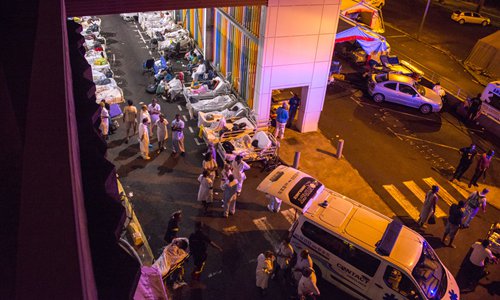 Patients and employees wait to be dispatched to other hospitals outside the University Hospital (CHU) of Pointe-a-Pitre in the French overseas island of Guadeloupe following their evacuation late Tuesday when a violent fire broke out at a control room in the hospital. There were no casualties, but 1,200 people were evacuated. Photo: AFP