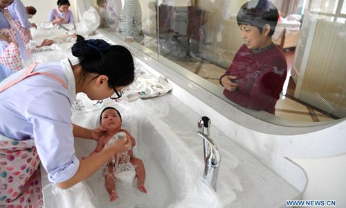 Staff members bath babies in a postnatal confinement center in Hefei, capital of east China's Anhui Province, Dec. 1, 2017. About 17.23 million babies were born in 2017, of which 51 percent have an older sibling, according to the National Health and Family Planning Commission. However, the total number of births fell by about 630,000 compared with 2016 while percentage of the population aged over 60 rose from 16.7 percent in 2016 to 17.3 percent in 2017. (Xinhua/Liu Junxi)
