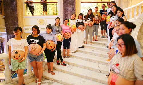 Pregnant women show paintings on their bellies drawn by their husbands during an event celebrating the Father's Day in Nantong, east China's Jiangsu Province, June 18, 2017. About 17.23 million babies were born in 2017, of which 51 percent have an older sibling, according to the National Health and Family Planning Commission. However, the total number of births fell by about 630,000 compared with 2016 while percentage of the population aged over 60 rose from 16.7 percent in 2016 to 17.3 percent in 2017. (Xinhua/Zhu Haochen)