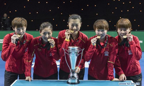Wang Manyu, Liu Shiwen, Ding Ning, Zhu Yuling and Chen Xingtong (From L to R) of China pose with the trophy after the women's team final against Japan at the ITTF Team World Cup in London, Britain on Feb. 25, 2018. China claimed the title with 3-0. (Xinhua/Stephen Chung)