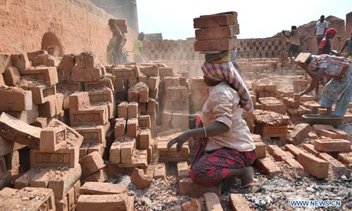 Indian women work in a brick factory on the outskirts of Agartala, capital of the northeastern state of Tripura, India, on March 7, 2018, ahead of the International Women's day. (Xinhua/Stringer)