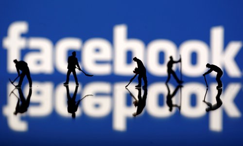 Figurines are seen in front of the Facebook logo in this illustration taken on Tuesday. Photo: VCG