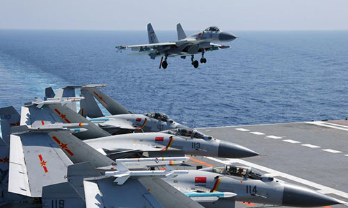 A ship-borne J-15 fighter jet prepares to land at the flight deck of the aircraft carrier Liaoning (Hull 16). A Chinese Navy flotilla including aircraft carrier Liaoning has conducted a series of exercises in the South China Sea since the grand naval parade last Thursday. (Photo/eng.chinamil.com.cn)