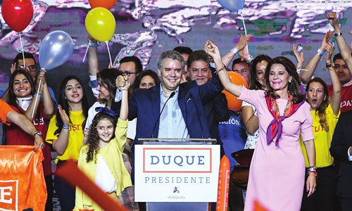 Colombian presidential candidate Ivan Duque (center), of the Democratic Center party celebrates with supporters next to his running mate Marta Lucia Ramirez (right) and one of his daughters (left), after winning the first round of the Colombian presidential election, in Bogota on Sunday. The conservative candidate won the first round of Colombia's presidential election Sunday but fell short of the 50 percent threshold needed to avoid a runoff next month. The 41-year-old senator will face former guerrilla leader Gustavo Petro on June 17, the first leftist candidate to contest a runoff election in Columbia. Photo: AFP