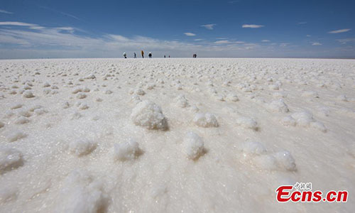 A view of the Qarhan salt lake in Golmud, Northwest China's Qinghai Province, July 25, 2018. The Qarhan salt lake, with a total area of 5,856 square kilometers, is the largest salt lake in China. The lake's abundant deposit of halide salts makes it a major mineral center. In the vast lake, the salt blossoms like flowers and takes the form of pillars, corals and pearls. (Photo: China News Service/Fu Yu).
