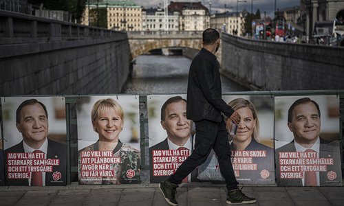 A man walks past Swedish election posters of the leader of the Social Democrats and Swedish Prime Minister Stefan Loefven, Swedish Minister for Finance Magdalena Andersson (second from right) and Sweden's Foreign Minister Margot Wallstrom (second from left) on Saturday in Stockholm. The general elections in Sweden will take place on September 9. Photo: AFP