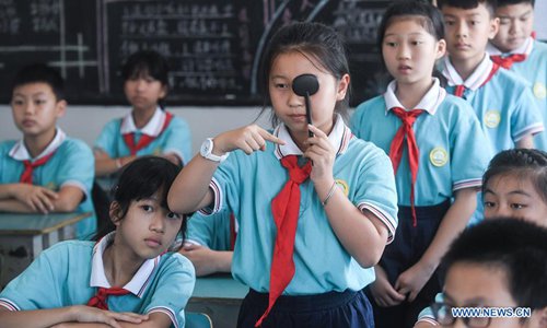 A student checks the eyesight in Donglin primary school in Donglin Township of Huzhou City, east China's Zhejiang Province, Sept. 4, 2018. Classes are being taken to popularize the knowledge of protecting eyes as China aims at curbing the rise in nearsightedness-or myopia-among children and teenagers. (Xinhua/Xu Yu)