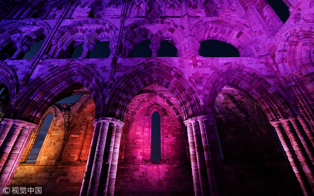 Spooky lights illuminate the historic ruins of Whitby Abbey in the UK
