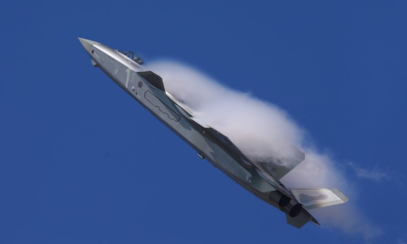 China's J-20 stealth fighter jet displays its new coating of stealth material and flies over the exhibition hall at Airshow China 2018 on Tuesday. Photo: Cui Meng/GT