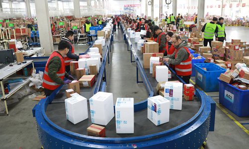 Staff at a logistic warehouse in Shenyang, Northeast China's Liaoning Province work overtime on Friday for China's Double 11 - November 11 - shopping festival. Over 1,000 logistics staffers in the warehouse are working 24 hours to prepare for the online shopping carnival, which brought orders worth 168.2 billion yuan ($ 26.5 billion) in 24 hours last year. Photo: IC
