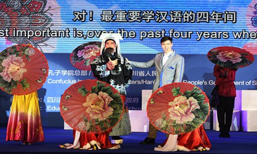 A Chinese Peking Opera artist (left) performs with a foreign student at the opening gala of the 13th Confucius Institute Conference on Tuesday in Chengdu, Southwest China's Sichuan Province. University chancellors and headmasters from 150 countries and regions, together with nearly 1,500 Confucius institute delegates attended the event. Photo: VCG