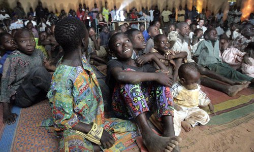 African children in a remote village in Burkina Faso watch a free film provided by Ambulant Digital Cinema in 2005. Photo: AFP