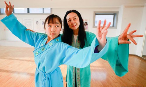 Meng Qingmei (R), a performer of Xuyi Huangmei Opera Troupe, teaches a student Huangmei Opera, in Xuyi County of east China's Jiangsu Province, Dec. 16, 2018. Performers of the troupe have been teaching local students Huangmei Opera in recent years to promote the traditional opera. (Xinhua/Zhou Haijun)