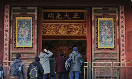 Visitors to the Palace Museum in Beijing tour an exhibit themed on traditional celebrations of China's Spring Festival. Pictures with menshen, or door gods - figures representing courage - are posted on doors to ward off evil spirits. Spring Festival will fall on February 5. Photo: IC