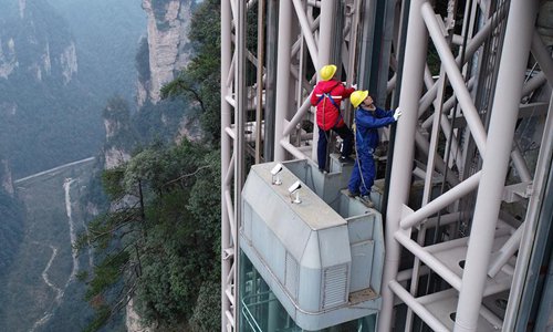 Staff members check the condition of an elevator at the Wulingyuan scenic area in Zhangjiajie City, central China's Hunan Province, Jan. 24, 2019. The Wulingyuan scenic area has strengthened the inspection and safeguard on the transport infrastructures to secure the safety of tourists during the seven-day Spring Festival holidays starting from Feb. 4. (Xinhua/Wu Yongbing)