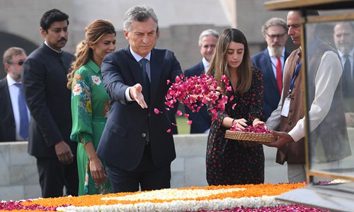 Argentina's President Mauricio Macri (4th from left), his wife Juliana Awada (3rd from left) and his  daughter Valentina Barbier pay tribute at Rajghat, the memorial for Mahatama Gandhi, in New Delhi on Monday. Macri is on a three-day state visit to India. Photo: AFP
