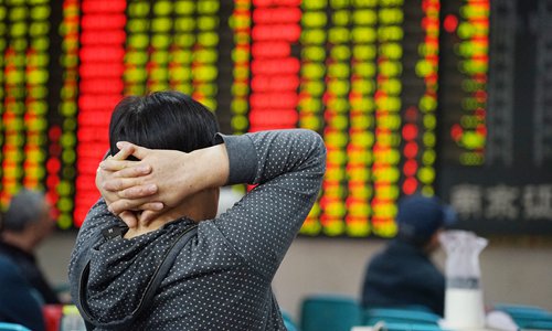 An individual investor watches stock prices at a stock exchange in Nanjing, East China's Jiangsu Province on Monday. Photo: VCG