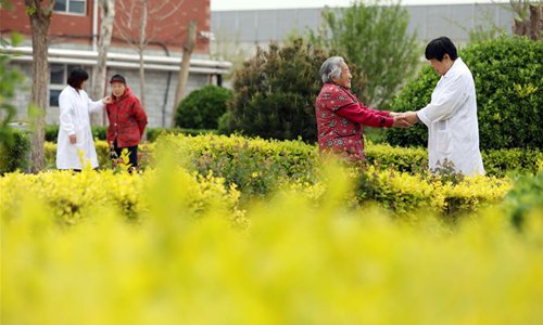 Elderly citizens are accompanied by medical care personnels at an elderly care center in Taocheng District of Hengshui City, north China's Hebei Province, May 5, 2019. Chinese economy is transitioning from high-speed growth to high-quality development. (Photo: Xinhua)