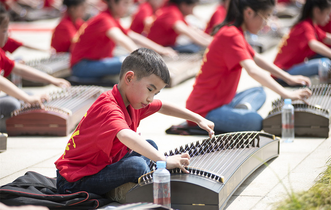 Children play traditional Chinese instrument guzheng to celebrate China