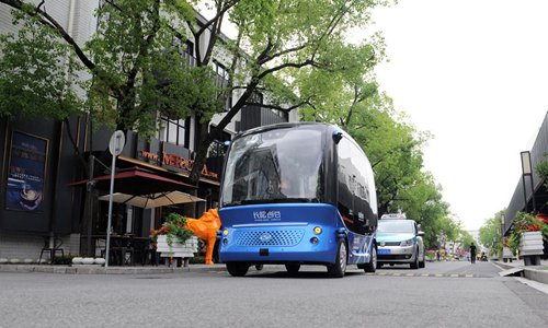 A self-driving bus is seen running on a road of Changyang Campus in Yangpu district, east China's Shanghai, June 21, 2019. In recent years, Yangpu District has vigorously developed Artificial Intelligence (AI) industry in the process of industrial transformation, making efforts to establish several innovation zones focusing on AI such as Changyang Campus. (Xinhua/Ren Pengfei)