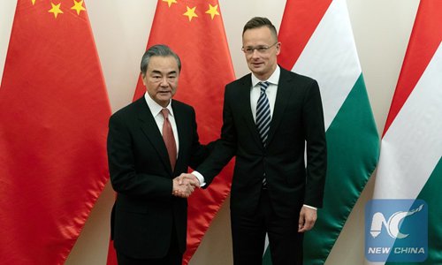 Visiting Chinese State Councilor and Foreign Minister Wang Yi (L) shakes hands with Hungarian Minister of Foreign Affairs and Trade Peter Szijjarto prior to their talks in Budapest, Hungary, July 12, 2019. (Photo: Xinhua)