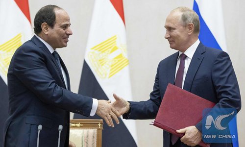 Russian President Vladimir Putin (R) shakes hands with Egyptian President Abdel-Fattah al-Sisi during their talks in Sochi on October 17, 2018.