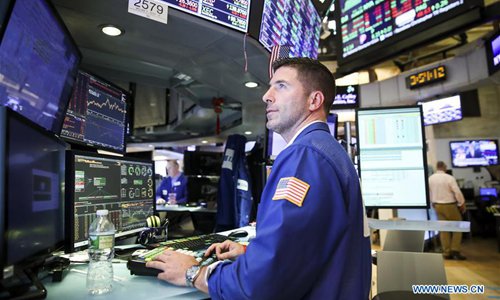 A trader works at the New York Stock Exchange in New York, the United States, on July 13, 2018. US stocks closed higher on Friday. The Dow Jones Industrial Average rose 94.52 points, or 0.38 percent, to 25,019.41. The S&P 500 rose 3.02 points, or 0.11 percent, to 2,801.31. The Nasdaq Composite Index rose 2.06 points, or 0.03 percent, to 7,825.98. (File photo: Xinhua)