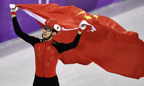 Chinese skater Wu Dajing celebrates winning gold in the men's 500-meter short-track speed skating at the Winter Olympics in Pyeongchang, South Korea on February 22, 2018. Photo: VCG